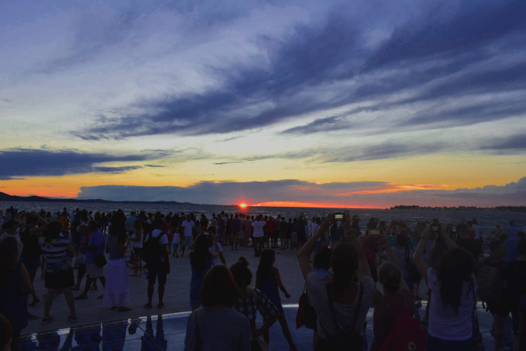 Sunset with crowd at 'Greeting To The Sun' - Zadar, Croatia