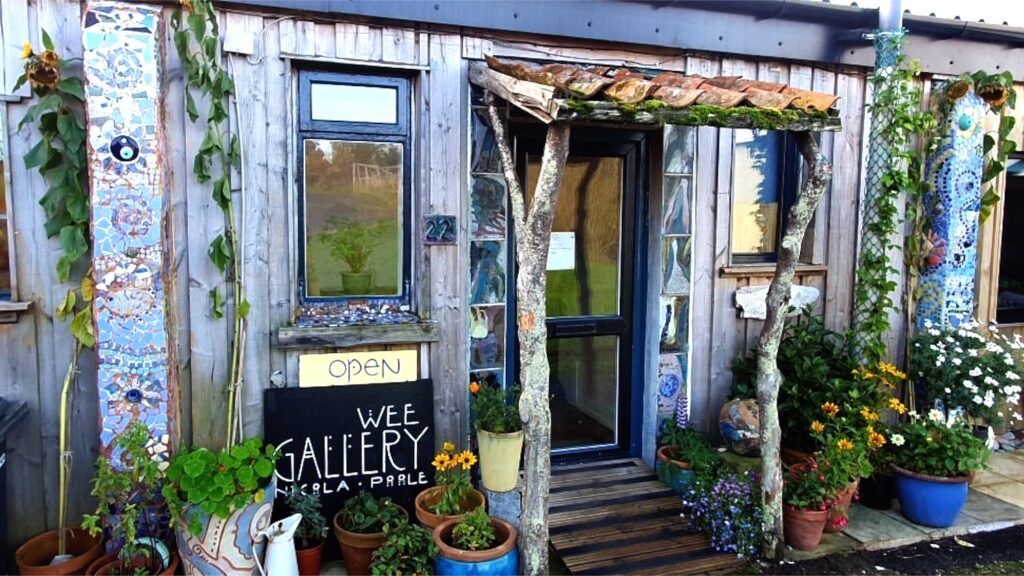 craft shop with lots of plants outside and a sign which says 'wee gallery'