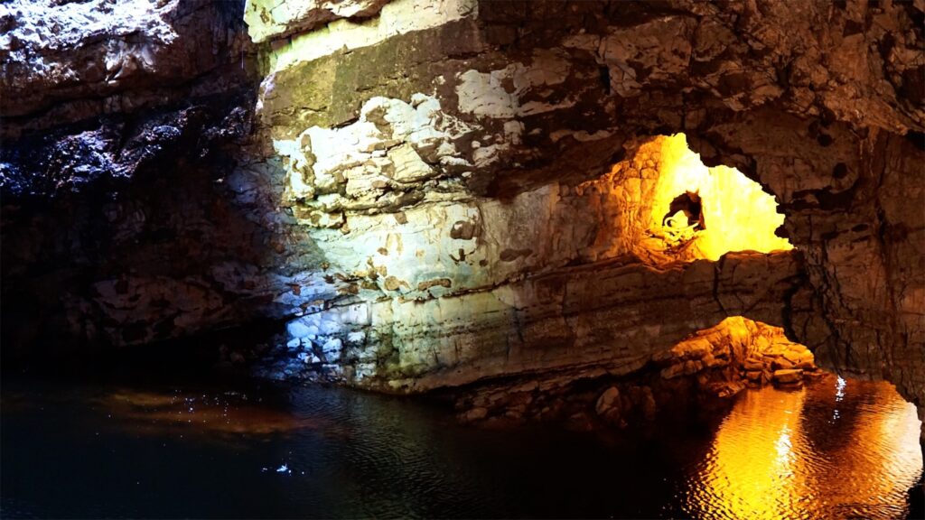 cave with water at base of it. Smoo Cave is a destination on the north coast 500 NC500