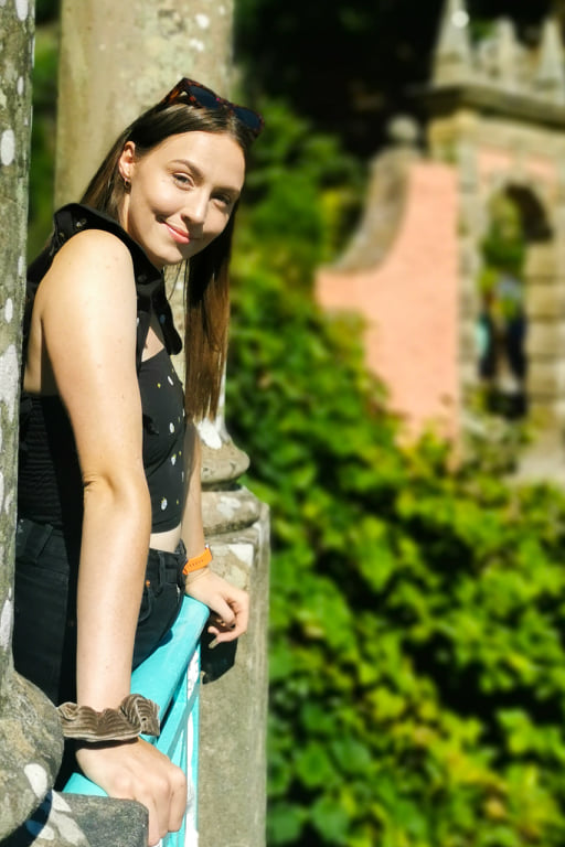 Image of a girl stood on a balcony in Portmeirion, Wales. This balcony overlooks the central green area and has one of the best views in Portmeirion