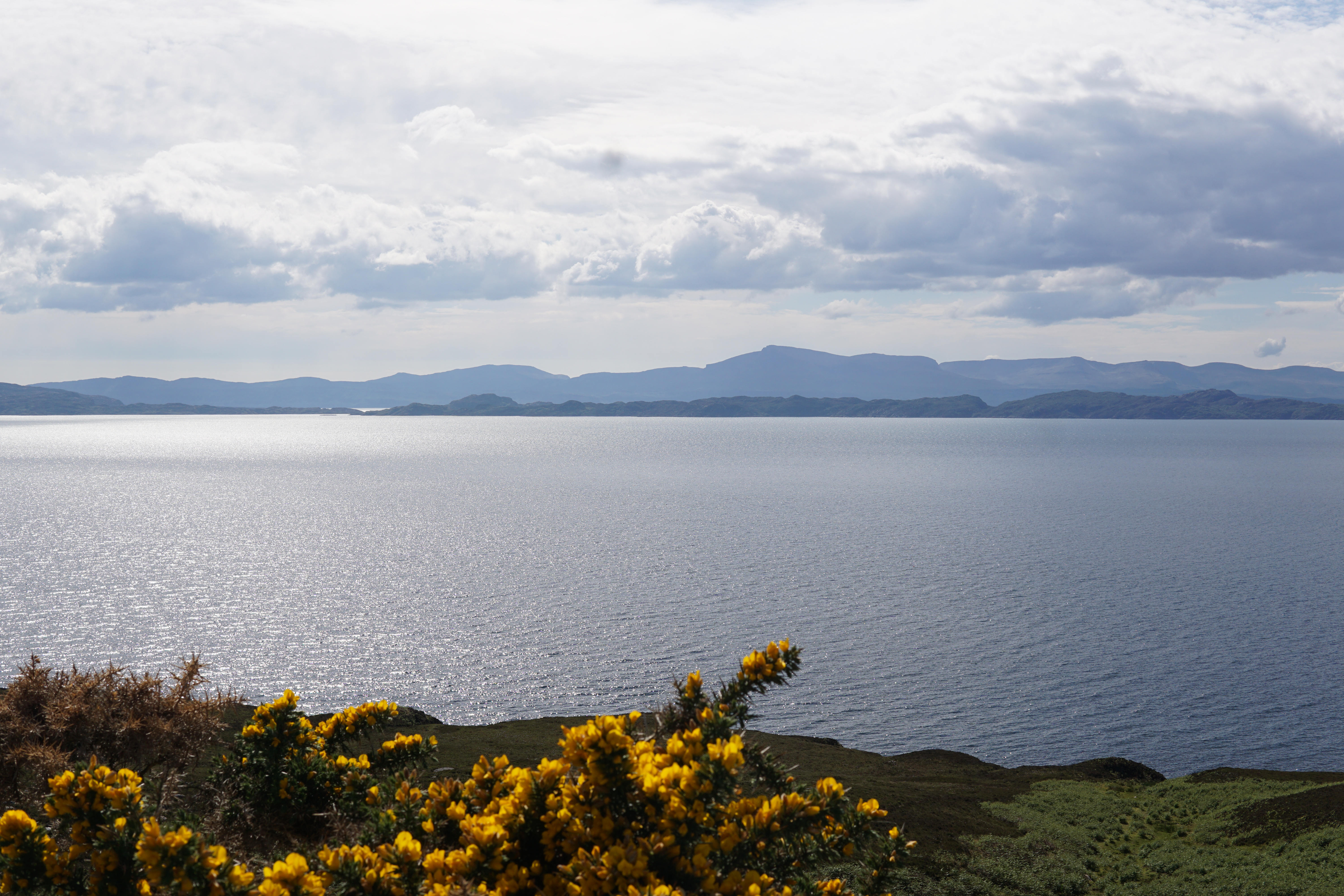 Image looking out to the Isle of Skye, Rona, and Rassay from a layby near Applecross