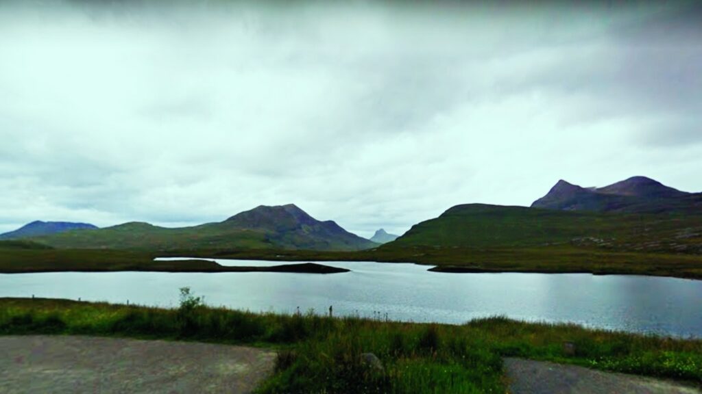 The view from the car park at the Knockan Crag Visitor Cetre. It looks out over a loch and into the mountains.